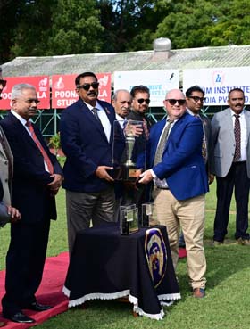Mysore Race Club Chairman K T Balakrishna presenting the Zavaray S Poonawalla Mysore 1000 Guineas trophy to James McKeown whose ward Royal Legacy won this event at Mysore on Friday.